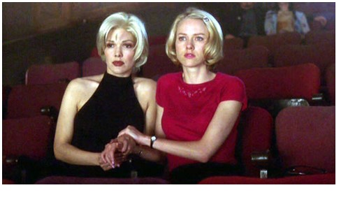 Two women sitting next to each other in a movie theater.